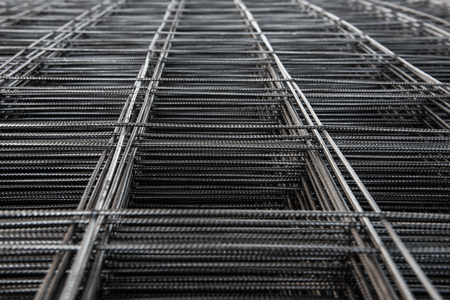 Pile of wire mesh. Reinforcement material of concrete pouring. Depth of field concept. Selection focus to texture of material.の写真素材
