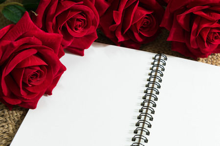 Daily note-book of love and red rose on a wooden background. for valentine dayの写真素材