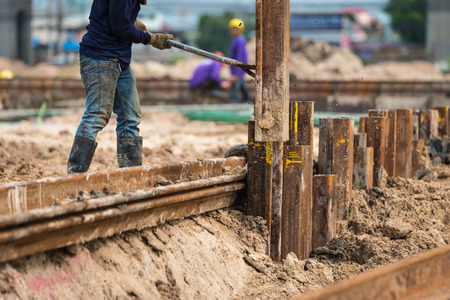 Retaining wall steel sheet pile driving machine workの写真素材