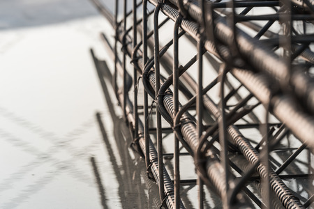 Reinforcement of concrete work. Using steel wire for securing steel bars with wire rod for reinforcement of concrete or cement. focus to steel wireの写真素材