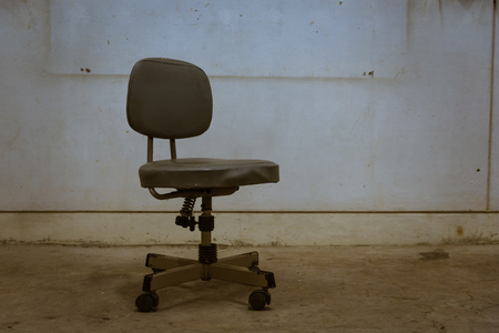Office chair old in the dim lightの写真素材