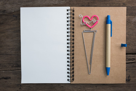 Notebook and pen on wooden table. Backgrounds for text memo in valentine day conceptの写真素材