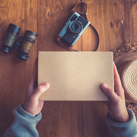 Top view of young man out his hand to give the package box or gift box for summer trips., The wonder what's in the packages box.の写真素材