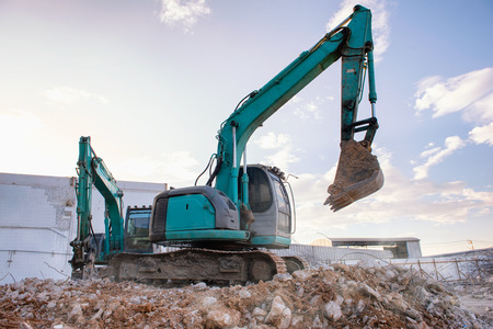 Heavy equipment excavator demolition demolish machine in construction site. Danger in construction sites and safety first concept.の写真素材
