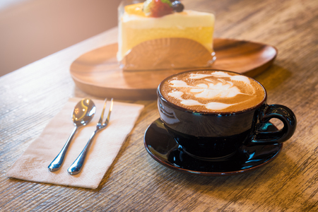 Cappuccino, Latte Coffee Art in a cup. Fresh morning coffee on the wooden table in the bakery cafeの写真素材
