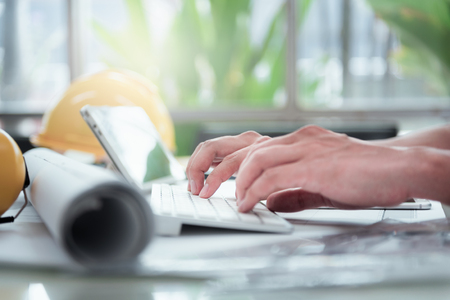 Close-up Hand of Engineer or Architecture Interior Designer work on keyboard in the modern office....