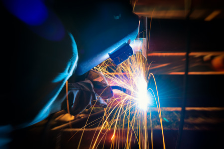 Welding work for steel. Welder industrial in the factory. Harm will happen to health of welder smoke...