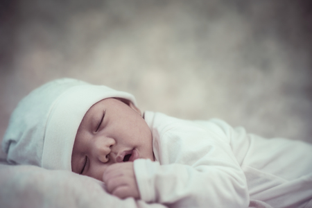Newborn baby boy sleeping sweetly on the stomach.の写真素材