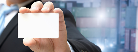 Businessman showing a business card, Card in the hand for insert contract text and Coordinate about logistic business.の写真素材