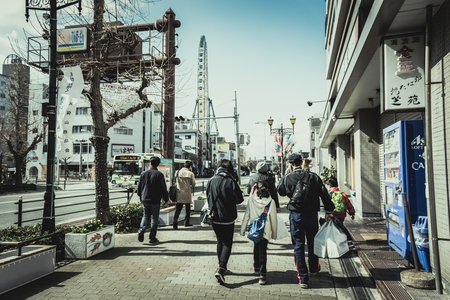 OSAKA, JAPAN - MAR 2015 : Japanese people walking street in the city. Cinematic color tone filter.のeditorial素材