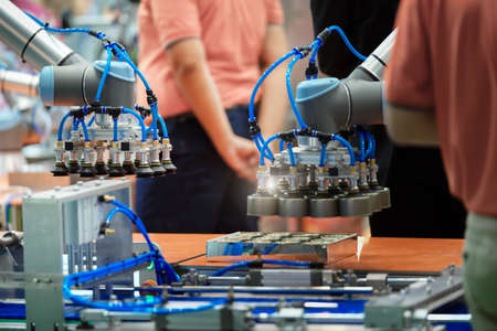 Robotic arm machine in factory picked up the convenience foods on conveyor for delivering them...