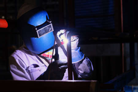 Welding steel pipe with Tungsten Inert Gas Welding of Manufacturer workshop for Industrial work. Gas metal arc welding, TIG welding torch.の写真素材