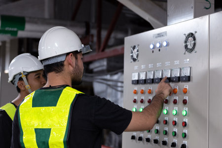 Electrical Engineer team working front HVAC control panels, Technician discussion and training daily...