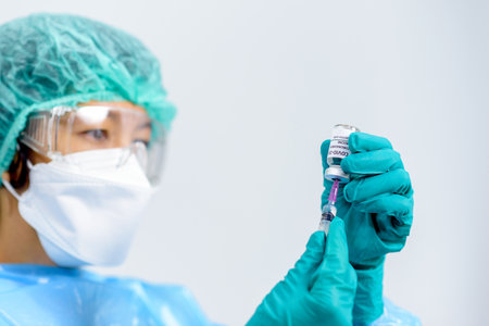 vaccine vial in female doctor hands and holds  injection syringe vaccine for  cure,  Virus Treatment, Medicine and Healthcare concept. Selection focus on vial..の写真素材