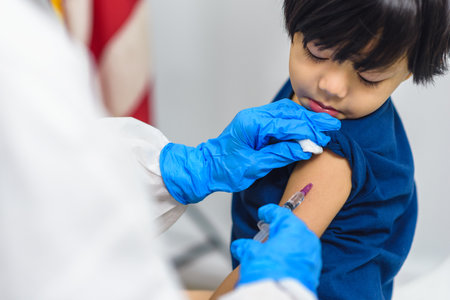 Doctor holding syringe subcutaneous vaccine for child or Pediatrician vaccinating a little boy in pediatric clinic, Virus prevention, Health careの写真素材