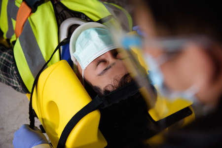 First aid for injuries in work accidents. Using first aid equipment support to loss of feeling or...
