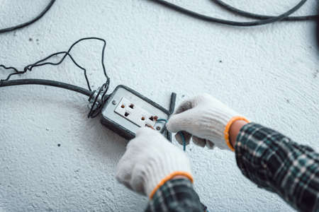 Hand connecting power outlet to an electric tool no electrical plug cause electric shock, Be unaware...