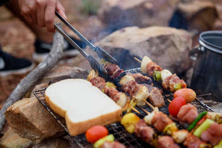 Close up grilling barbecue in the campground at summer camp travel, Skewers of pork and beef fillet on barbecue party in camping, Summer Camp Travel one activity for relaxing.の写真素材