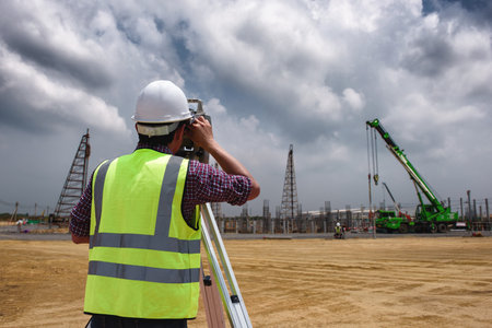 Construction Surveyors distance measurement in building construction area, Surveying for making layout plans is a graphical representation of the lay of the land startup construction work.の写真素材