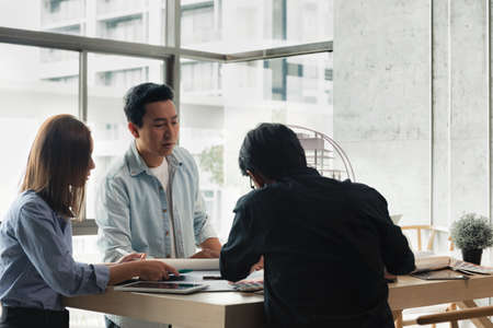 Heads of each department meeting together between Construction Engineers with Architect and Sales. Brainstorm management an idea to find a way to deal with construction and communication for sales.の写真素材