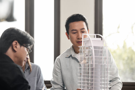 Heads of each department meeting together between Construction Engineers or Architect and Sales. Brainstorm management an idea to find a way to deal with construction and communication for sales.の写真素材