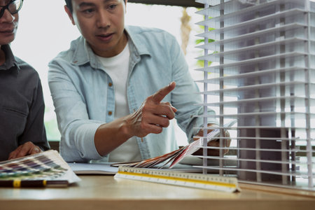 Meeting together between Engineers and Architect for highrise buildings in city. Brainstorm an idea to find a way to deal with construction and communication for design. Focus on hand pointing modelの写真素材
