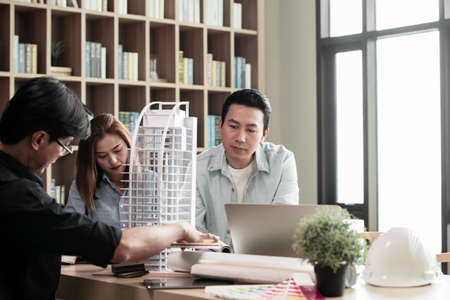 Heads of each department meeting together between Construction Engineers or Architect and Sales. Brainstorm management an idea to find a way to deal with construction and communication for sales.の写真素材