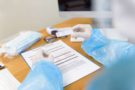 Hand of doctor or nurses holding rapid antigen test kit of Patient for coronavirus, COVID-19 while...