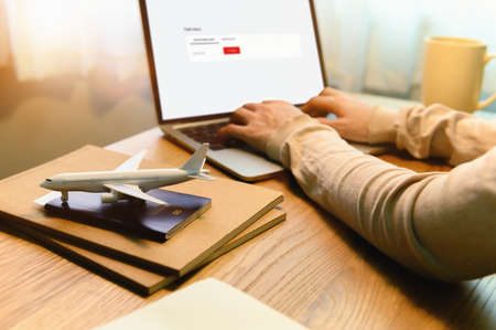 Flight status, Asian female student abroad checking flight status and Preparation Passport with Digital Documentation of COVID-19 Certificate in College for study at university. Focusing on Airplane.の写真素材