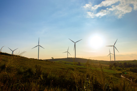 Landscape of Wind turbines farm with a moody sky at sunset, Renewable energy systems electricity,...