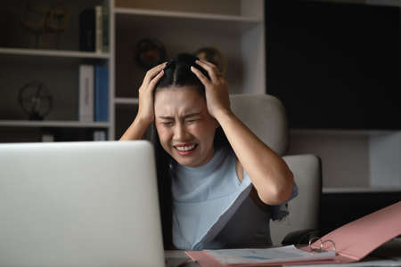 Business Woman with dress long hair sit on the working table in meeting room use laptop to work...