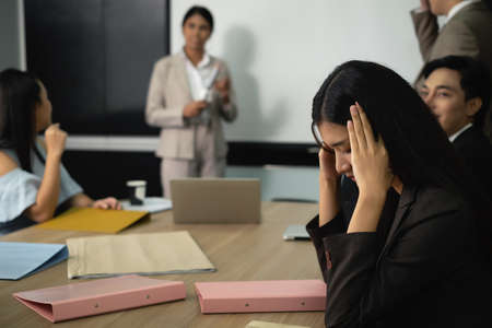 Meeting in conference room many file on the table manager present to team front of stressful lady and intention lady with projector monitor, laptopの写真素材