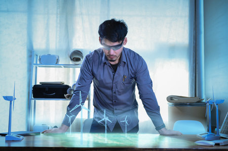 Energy engineer wearing AR headset or hologram glasses future, prototype design of wind turbine farm...