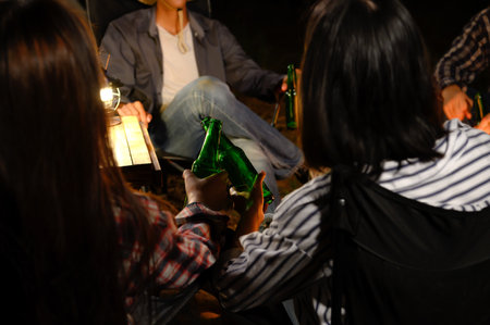 Group Camping Outdoor Party with BBQ Grill, Beer, sit and talk with Sadness and Relaxation, Friendship under the Starry Night Sky. Weekend Getaway concept.の写真素材