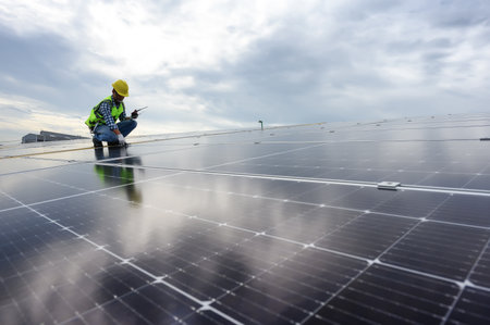 Technician Inspector Quality in Solar Roof Panel Installation, Sustainable Photovoltaic Work for Factory Buildings. Natural Energy Sources Infrastructure Development in Efficiencyの写真素材