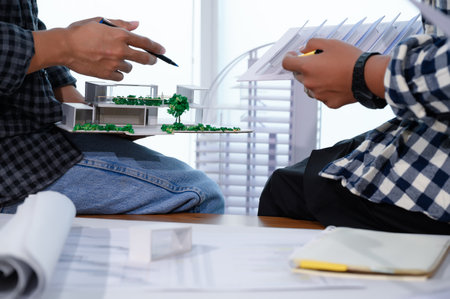 Asian Architect Students Studying Modern House Design and Finding Ways to Utilize Natural Alternative Energy or Use Natural Renewable Energy, Concepts of Eco-Friendly Living for a Sustainable Future.の写真素材