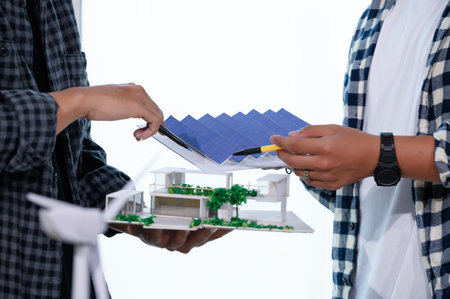 Asian Architect Students Studying Modern House Design and Finding Ways to Utilize Natural Alternative Energy or Use Natural Renewable Energy, Concepts of Eco-Friendly Living for a Sustainable Future.の写真素材