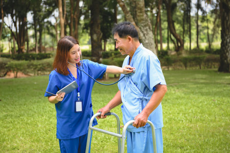 Asian Young Female Doctor Check Senior Patient's Health Condition and Notes, Provide Encouragement During Treatment. Rehabilitation or Physical Therapy of Asian Retired Patients with Walking Aids.の写真素材