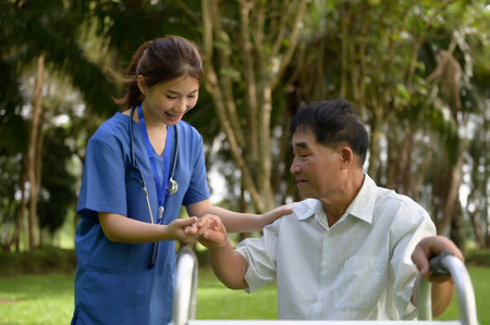 Asian Female Doctor Touching Hand of the Senior Patient to Give Encouragement while Maintaining Physical Health Rehabilitation..の写真素材