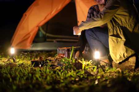 Close-up of barbecue meal grill in the wilderness of backpacker group. Grilled meals ready to eat...
