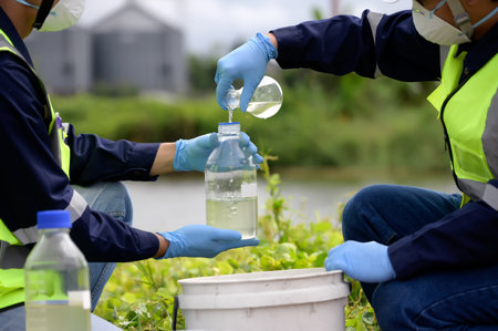 Environmental Engineers Team Take Water Samples at Natural Water Sources. Water that smells bad Near Farmland, Fish Ponds May Be Contaminated by Toxic Suspicious Pollution Sites.の写真素材