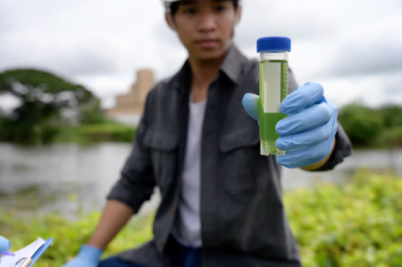 Environmental Engineers Inspect Water Quality, pH Test and Take Water sample notes in The Field Near...