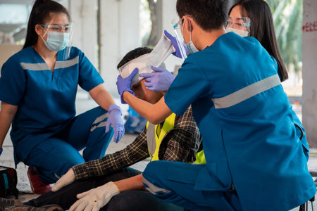 First aid team helped with a worker accident on construction site, Builder broken head accident on concrete floor.の写真素材