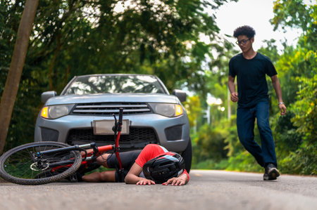 Young Asian man driving a car crashes into a cyclist falls and injures, Cyclist in need of urgent aid, Unexpected Roadside Encounter and Immediate Assistance for Outdoor Mishaps Car Crash.の写真素材