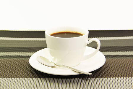 White ceramic cup of black coffee on tablematの写真素材