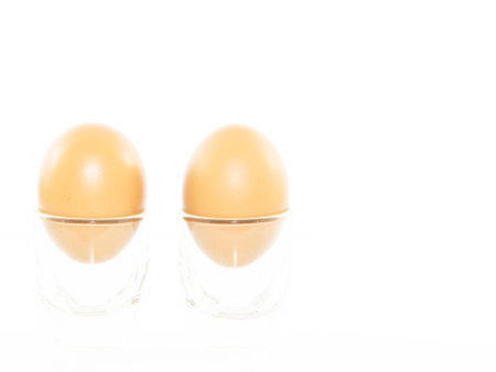 Breakfast eggs in shot glass on white backgroundの写真素材