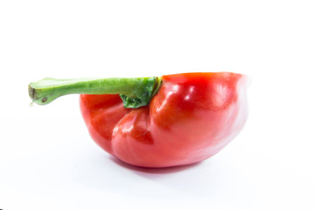 Red bell chili half sliced view from side on white background
