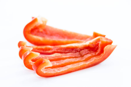 Fresh red bell chili sliced ingredient on white background