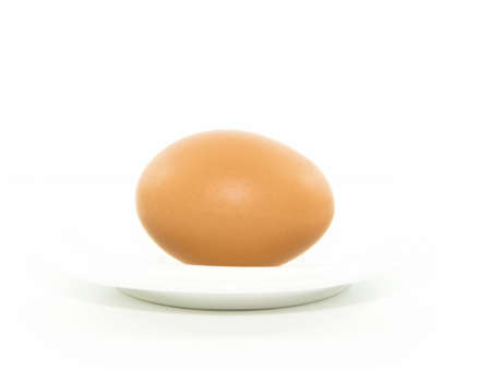 Fresh egg in white plate on white backgroundの写真素材