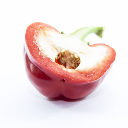 Spicy red bell chili half sliced on white backgroundの写真素材
